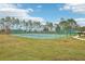 Outdoor tennis court with surrounding fence and grassy area at 648 Cortona Dr, Orlando, FL 32828
