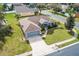 Aerial view of a single-Gathering home with a two-car garage and landscaped yard at 707 Terranova Ave, Winter Haven, FL 33884