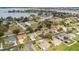 Wide aerial shot of a neighborhood with manicured lawns, mature trees, and a tranquil lake enhancing the community's appeal at 707 Terranova Ave, Winter Haven, FL 33884