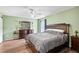 Main bedroom with a king-size bed and ceiling fan at 707 Terranova Ave, Winter Haven, FL 33884