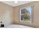 Cozy bedroom with a large window overlooking the yard and neutral carpet at 707 Terranova Ave, Winter Haven, FL 33884