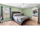 Light and airy bedroom with a double bed and wood floors at 707 Terranova Ave, Winter Haven, FL 33884