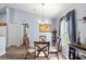 Bright dining room with glass table and four chairs, view of backyard at 707 Terranova Ave, Winter Haven, FL 33884