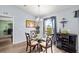 Bright dining room with glass table and four chairs, view of backyard at 707 Terranova Ave, Winter Haven, FL 33884