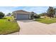 House exterior with gray siding, stone accents, and a two-car garage at 707 Terranova Ave, Winter Haven, FL 33884