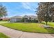 Gray house with stone accents, landscaping, and a curved sidewalk at 707 Terranova Ave, Winter Haven, FL 33884