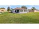 Rear view of house showing a screened porch and grassy backyard at 707 Terranova Ave, Winter Haven, FL 33884