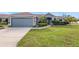 Single-story house with gray siding, two-car garage, and well-manicured lawn at 707 Terranova Ave, Winter Haven, FL 33884