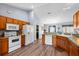 Open kitchen with white appliances and wood cabinets at 707 Terranova Ave, Winter Haven, FL 33884