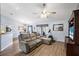 Spacious living room featuring a large sectional sofa and wood-look flooring at 707 Terranova Ave, Winter Haven, FL 33884