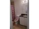Cozy bathroom with a black countertop vanity and a pink zebra shower curtain at 8203 Olympia Ct # 8203, Longwood, FL 32779