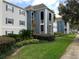 Two-story building with light blue and gray exterior, lush landscaping at 8203 Olympia Ct # 8203, Longwood, FL 32779