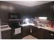 Dark kitchen cabinets, tile backsplash and black appliances at 8203 Olympia Ct # 8203, Longwood, FL 32779