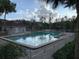 Community pool with lounge chairs and surrounding fence at 8203 Olympia Ct # 8203, Longwood, FL 32779