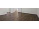 Empty bedroom with wood-look tile floors and access to hallway at 8231 Lynch Dr, Orlando, FL 32835