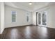 Large bedroom with dark hardwood floors and sliding glass doors at 8231 Lynch Dr, Orlando, FL 32835