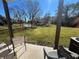 Relaxing patio overlooks a pond and grassy area with mature trees at 8513 Crystal Cove Loop, Kissimmee, FL 34747