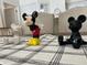 Three Mickey Mouse figurines on a table with a black and white checked tablecloth at 8513 Crystal Cove Loop, Kissimmee, FL 34747