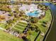 A stunning aerial view of resort amenities including the community pool and bocce ball at 8575 Hempstead Way, Mount Dora, FL 32757