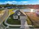 Aerial view of a house with a large backyard and lake view at 8575 Hempstead Way, Mount Dora, FL 32757