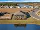 Aerial view of a house with a screened lanai overlooking a lake at 8575 Hempstead Way, Mount Dora, FL 32757