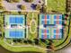 An aerial view showcases the well-maintained pickleball and bocce ball courts at 8575 Hempstead Way, Mount Dora, FL 32757