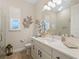 Elegant bathroom with a quartz vanity, large mirror, and modern fixtures at 8575 Hempstead Way, Mount Dora, FL 32757