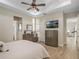 Main bedroom with a king-size bed, dresser, and a view of the backyard at 8575 Hempstead Way, Mount Dora, FL 32757