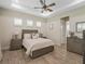 Guest bedroom with a queen-sized bed, dresser, and neutral color palette at 8575 Hempstead Way, Mount Dora, FL 32757