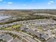 Aerial view of a residential neighborhood with houses, roads, and a wetland area at 9653 Early Loop, Groveland, FL 34736