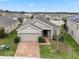 One-story house with a two-car garage and a brick driveway at 9653 Early Loop, Groveland, FL 34736