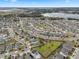 Aerial view of a residential community near a lake, featuring numerous homes and landscaping at 9653 Early Loop, Groveland, FL 34736