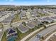 Aerial view of a residential neighborhood with houses, roads, and lush green spaces at 9653 Early Loop, Groveland, FL 34736