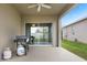 Covered patio with sliding glass doors and gas grill at 9653 Early Loop, Groveland, FL 34736