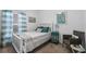 Cozy bedroom with a full bed, teal accents, and window at 9653 Early Loop, Groveland, FL 34736