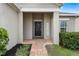 Inviting home exterior with a covered porch and a brick walkway at 9653 Early Loop, Groveland, FL 34736