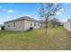 House exterior with fenced yard and air conditioning unit at 9653 Early Loop, Groveland, FL 34736