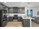 Modern kitchen with gray cabinets and quartz countertops at 9653 Early Loop, Groveland, FL 34736