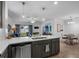 Modern kitchen island with white countertop and stainless steel appliances at 9653 Early Loop, Groveland, FL 34736