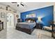 Main bedroom with blue accent wall and ensuite bathroom at 971 Worthington Ct, Oviedo, FL 32765