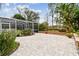 Brick paver patio with lush landscaping and pool enclosure in view at 971 Worthington Ct, Oviedo, FL 32765