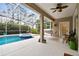 Covered patio with hammock overlooking the refreshing pool and spa at 971 Worthington Ct, Oviedo, FL 32765