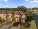 Aerial view of a two-story townhome with brown roof at 100 Napoli Dr, Davenport, FL 33897