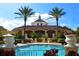 Inviting community pool with Spanish-style clubhouse in background at 100 Napoli Dr, Davenport, FL 33897