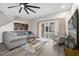 Living room with gray sofa, sliding glass doors, and ceiling fan at 100 Napoli Dr, Davenport, FL 33897