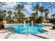 Resort-style pool with palm trees and lounge chairs at 100 Napoli Dr, Davenport, FL 33897