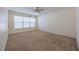 Large bedroom with carpet, window with blinds, ceiling fan at 108 Strait Dr, Davenport, FL 33897