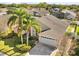 Aerial view of single-Gathering home with a two-car garage and palm trees at 11016 Orangeshire Ct, Ocoee, FL 34761