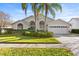 House exterior featuring a two-car garage and well-manicured lawn at 11016 Orangeshire Ct, Ocoee, FL 34761