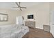 Main bedroom with king bed, dresser, and large TV at 11016 Orangeshire Ct, Ocoee, FL 34761